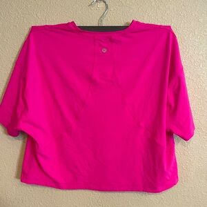Bright pink Lululemon cropped shirt